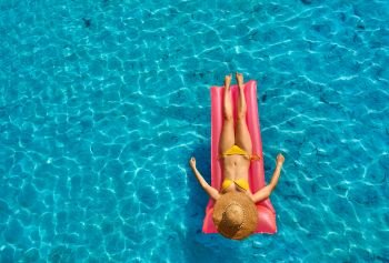 Woman relaxing on inflatable mat float at the beach