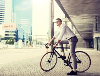 lifestyle, transport and people concept - young man with bicycle and headphones on city street. man with bicycle and headphones on city street