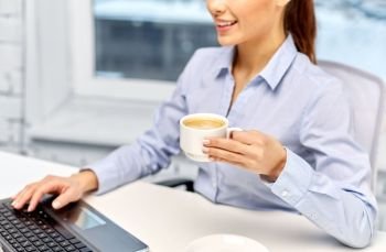 business, deadline and technology concept - close up of happy smiling businesswoman with coffee and laptop at office. businesswoman with coffee and laptop at office
