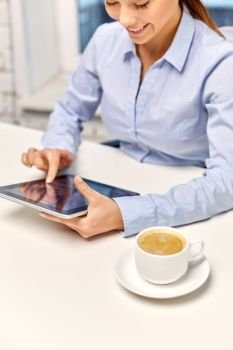 business, technology and people concept - happy smiling businesswoman with tablet pc computer drinking coffee at office. businesswoman with tablet pc and coffee at office
