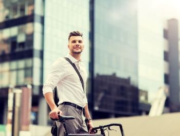 business, lifestyle, transport and people concept - young man with bicycle on city street. young man with bicycle on city street