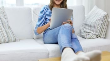 technology and people concept - close up of happy smiling teenage girl with tablet pc computer at home. teenage girl with tablet pc computer at home