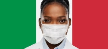 health, medicine and pandemic concept - close up of african american female doctor or scientist in protective medical mask over italian flag background. african american doctor in medical mask
