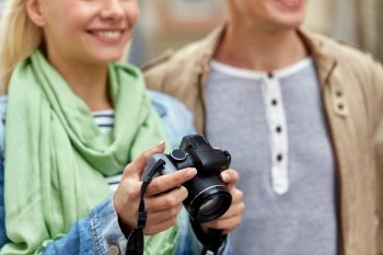 travel, technology and photography concept - close up of happy smiling couple with digital camera. close up of smiling couple with digital camera