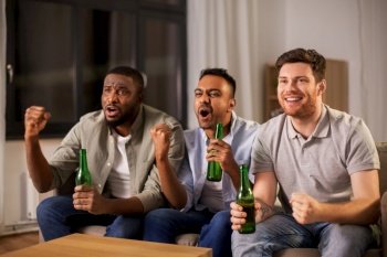 friendship, emotions and leisure concept - happy smiling male friends or fans drinking beer at home. happy male friends or fans drinking beer at home