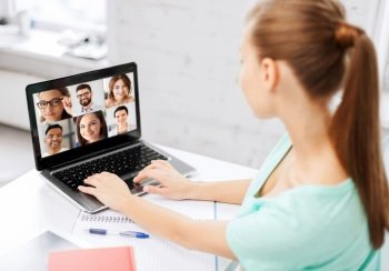 technology, remote job and online education concept - young woman or student girl with laptop computer having video call with colleagues or teachers at home. woman with laptop has video call with colleagues