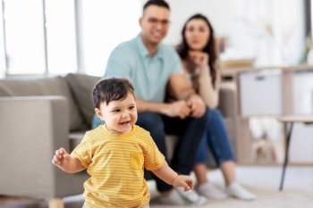 childhood, family and people concept - happy baby boy and parents at home. happy baby boy and parents at home