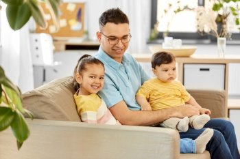 family, child and motherhood concept - happy father with little daughter and baby son at home. happy father with little children at home