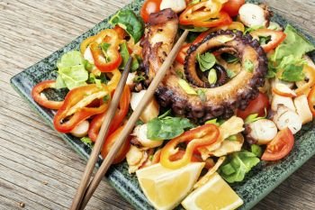 Spring or summer salad with vegetables and octopus.Seafood salad. Vegetable salad with octopus.