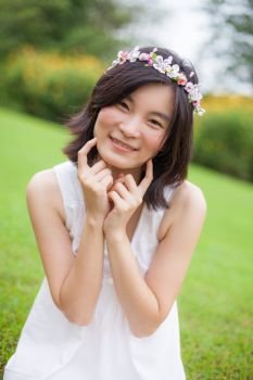 Beautiful asian young woman with a crown of flowers