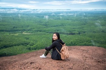 Young woman sitting on a mountain top at Phu Sing, Hin Sam Wan, Buengkan, Thailand
