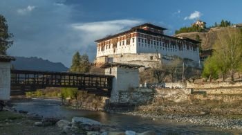 Rinpung Dzong and Nemi Zam Bridge - a large Buddhist monastery and fortress of the Drukpa Lineage of the Kagyu school near Paro in the Kingdom of Bhutan.