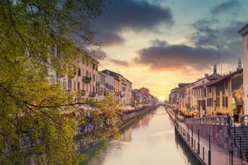 Naviglio Grande canal at sunset,on the sides of the canal the typical bars, restaurants and typical shops of the 