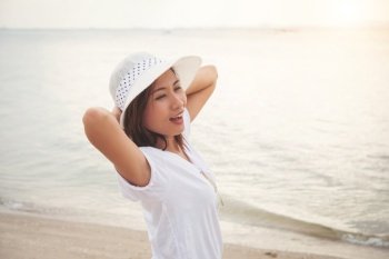 Beautiful woman in vacation at sea, Standing on the beach. Freedom enjoy. Women lifestyle concept.