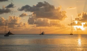 Sunset view of yachts anchored in the lagoon, Britannia bay, Mustique island, Saint Vincent and the Grenadines, Caribbean sea