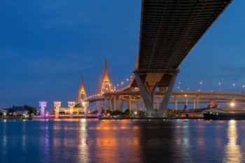 Bhumibol Bridge and Chao Phraya River in structure of suspension architecture concept, Urban city, Bangkok. Downtown area at night, Thailand.