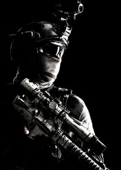 Shoulder portrait of army elite troops sniper, anti-terrorist tactical team marksman wearing helmet with thermal imager, hiding face behind mask, armed rifle with optical scope, studio shoot on black. Army elite troops sniper low key studio portrait