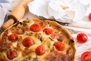 pie with  cheese brie and cherry tomatoes - french cuisine
