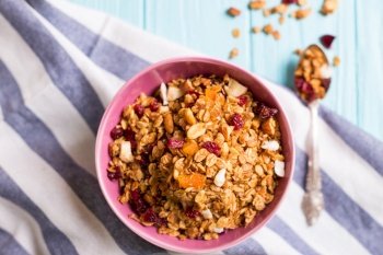 healthy breakfast. appetizing healthy granola in bowl on blue wooden background
