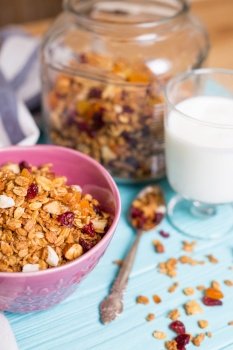 healthy breakfast. appetizing healthy granola in bowl on blue wooden background
