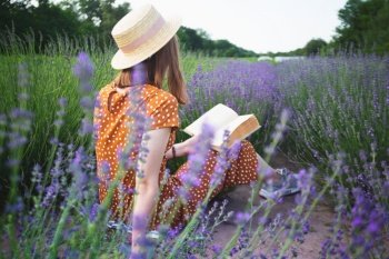 Provence - girl reading a book in a lavender field 
