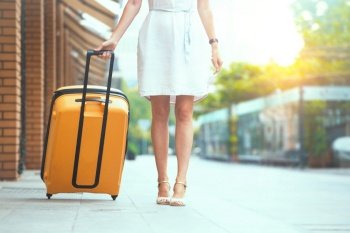 girl traveler and her yellow  luggage. wonderful travel
