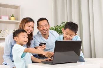Asian family using laptop to perform online shopping