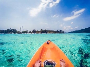 kayaking in crystal clear tropical waters - kayak heading to isolated beach in Ko Tarutao national park