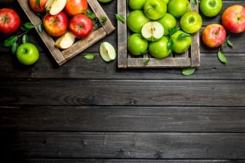 Red and green juicy apples in wooden boxes. On wooden background.. Red and green juicy apples in wooden boxes.