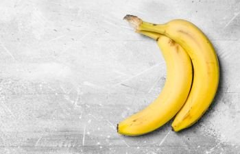 The smell of fresh bananas. On white rustic background.. The smell of fresh bananas.