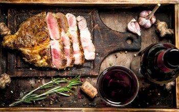 Beef grill with red wine. On a wooden table.. Beef grill with red wine.