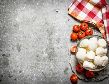 Mozzarella with tomatoes . On the stone table.. Mozzarella with tomatoes .