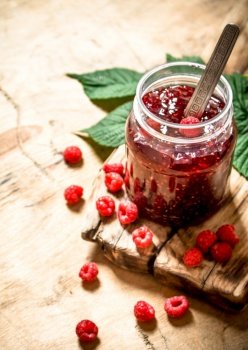 Sweet jam with raspberries. On a wooden table.. Sweet jam with raspberries.