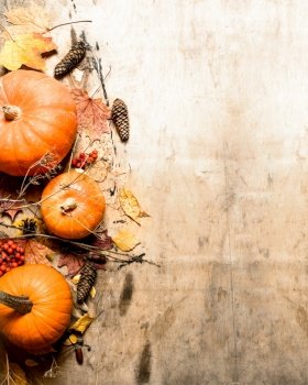 Autumn harvest. Ripe pumpkin with leaves. On wooden background.. Autumn harvest. Ripe pumpkin with leaves.