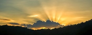 Panorama summer sunset golden cloud summertime light sunny day cloudscape mountain scene. Panoramic sunset golden skyline sun beam over cloud climate background. Heaven gold landscape panoramic banner