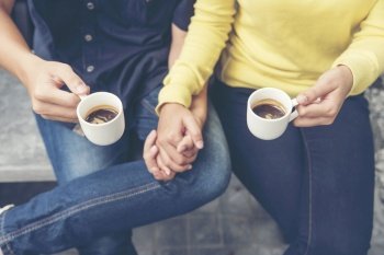 Couple lover having date and drinking a cup of coffee together. happy relation on cafe. coffee lover concept. Close up woman hands holding cup of coffee. Drinking coffee make people freshness