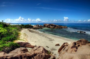 Idyllic and remote beach with granitic rocks in Anse Pierre La Digue island, Seychelles