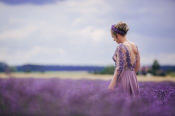 Portrait of beautiful romantic woman in purple dress in field of lavender. Portrait of beautiful romantic woman in purple dress in field of lavender.