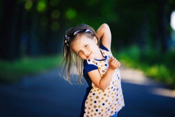 Cute little girl is having fun, jumping and laughing outdoors. happy childhood.. Cute little girl is having fun, jumping and laughing outdoors. happy childhood