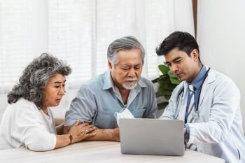 Doctor using technology laptop to explain and talking for auscultate Asian grandparent patient in house, healthcare with Long live and Elderly society, Prevent epidemic, Covid19 Disease concept