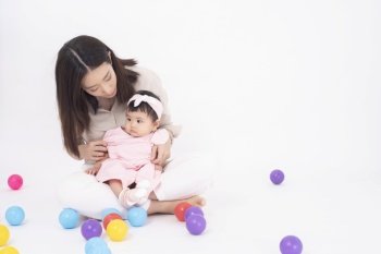 Asian mother and adorable baby girl are  happy on white background 