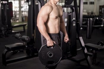 Muscular fitness man bodybuilder is workout  in gym