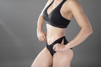 Beautiful fitness body builder woman in Studio 