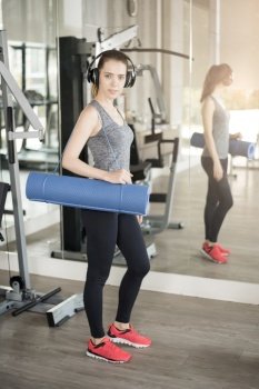 Pretty young sport woman is workout with mat  in gym, Healthy lifestyle 