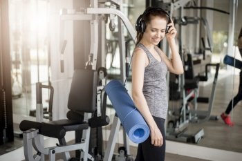 Pretty young sport woman is workout with mat  in gym, Healthy lifestyle 