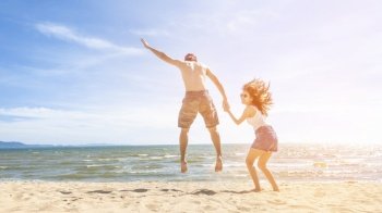 Couple is Jumping  in beach