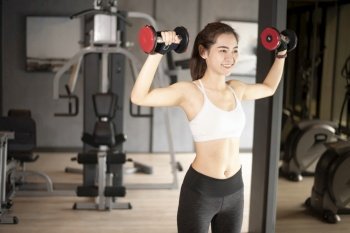 Beautiful asian woman is doing exercise in the gym 