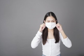Portrait of woman with surgical mask  in studio, Health care concept 