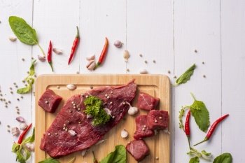 Raw beef on white wood background 