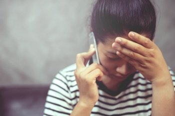 Woman is talking on the phone with boyfriend, she regrets breaking up with boyfriend